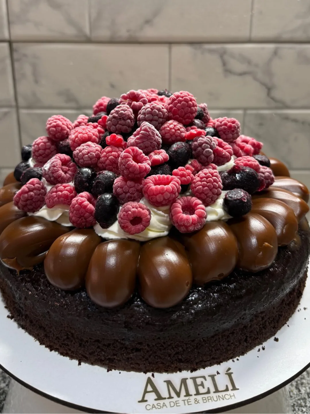 Torta de chocolate con frutos rojos y arándanos, decorada con caramelo